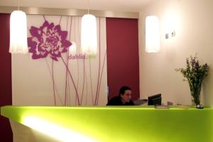 a man sitting at a desk with a laptop at Dahlia Inn in Prague