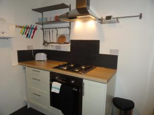 a kitchen with a stove and a counter top at Luckwell Too by Cliftonvalley Apartments in Bristol