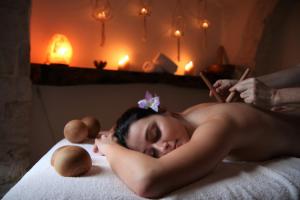 a naked woman laying on a bed in a room at Trulli Holiday Deluxe & Wellness in Alberobello