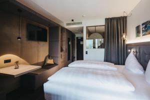 מיטה או מיטות בחדר ב-Hotel Rudolf