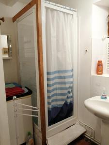 a shower with a glass door in a bathroom at La maison de Xenos in Nohant-en-Graçay