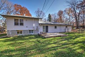 a white house with a porch and a yard at Quaint Duluth Hideaway with Private Fenced-In Yard! in Duluth