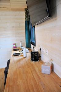 a kitchen with a long table in a tiny house at La Parenthèse in Bergerac