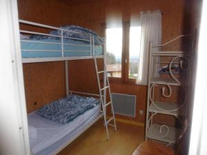 a room with two bunk beds and a window at Camping le Montbartoux in Vollore-Ville