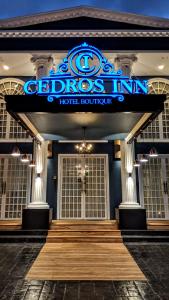 a hotel building with a sign on the front of it at Cedros Inn Boutique Hotel in Guayaquil