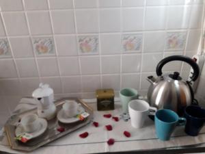 a kitchen counter with a tray and cups and a tea kettle at Sweet Carola in Bari