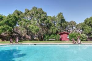 a swimming pool with two chairs and a picnic table at The Camp at Carmel Valley in Carmel Valley