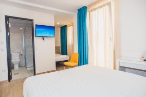a hotel room with a bed and a bathroom at Solesperit in Lloret de Mar