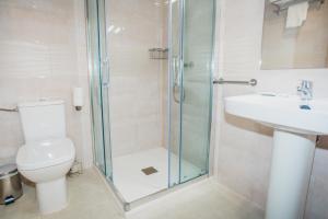 a bathroom with a shower and a toilet and a sink at Solesperit in Lloret de Mar