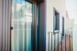 a glass door in a room with a staircase at Solesperit in Lloret de Mar