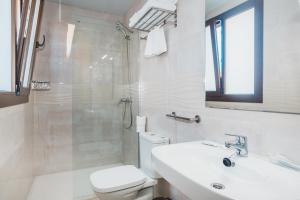 a bathroom with a shower and a toilet and a sink at Solesperit in Lloret de Mar