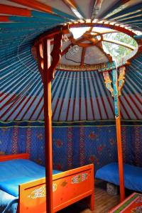 a interior of a yurt with a bed and a table at "Verdon Yourtes" Camping à la ferme in Angles +17 photos