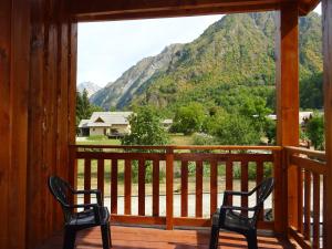 two chairs on a porch with a view of a mountain at Les Prés-Ronds in La Chapelle-en-Valgodemard