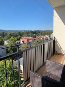 a balcony with two chairs and a view of a city at Apartment Sopot in Sopot