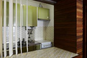 a kitchen with green cabinets and a stove at FLH Studio Cascais in Cascais