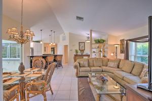 a living room with a couch and a table at Canalfront Home with Private Saltwater Pool and Dock! in Marco Island