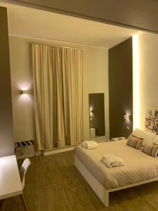 Postel nebo postele na pokoji v ubytování La Banchina Holiday Rooms