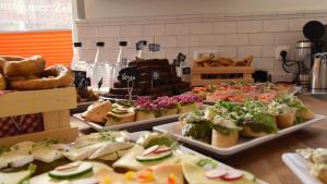 a buffet filled with different types of sandwiches and pastries at Haus Wopke in Borkum