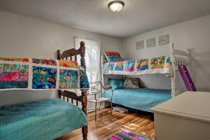 a room with two bunk beds and a table at Scenic Ludington Home about 1 Mile to Lake Michigan in Ludington