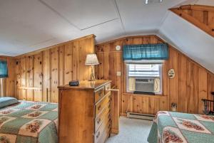 a bedroom with two beds and a dresser with a lamp at Sebago Lake Cottage with Patio and Beach Access! in North Sebago