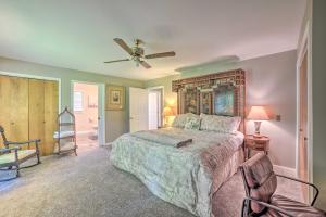 a bedroom with a bed and a ceiling fan at Calvert City Home, 8 Miles to Kentucky Lake! in Calvert City