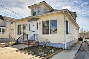 a white house with a front door and a porch at Old Ocean Beach Apt by Pier and Palace Playland in Old Orchard Beach