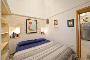 A bed or beds in a room at Ostuni Guest House