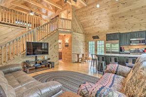 a living room with a couch and a television in a cabin at Palmerton Cabin with Game Room about 5 Mi to Blue Mtn in Palmerton