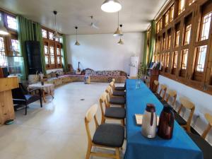 a room with a long table and chairs in it at Nirvana Organic Farm Inn in Yangshuo