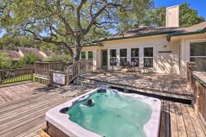 a hot tub on the deck of a house at Family-Friendly Home with Hot Tub, Fire Pit and Deck! in San Antonio