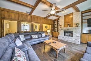 a living room with a couch and a fireplace at Family-Friendly Home with Hot Tub, Fire Pit and Deck! in San Antonio