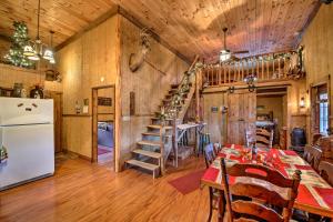a kitchen and dining room with a table and a refrigerator at The Bovard Lodge Rustic Cabin Near Ohio River! in Florence