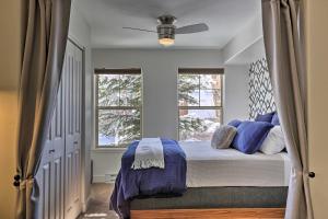 a bedroom with a bed with blue pillows and a window at Wildhorse Meadows Studio with Resort Gondola Access! in Steamboat Springs +26 photos