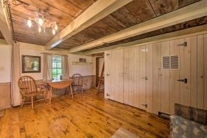 a room with a table and chairs and a wooden ceiling at Remote 1901 Studio Cabin with Loft - Pets Allowed! in Allenwood