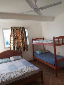 a bedroom with two bunk beds and a window at Habitaciones Villa Blosset in Posadas