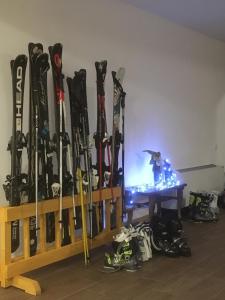 a room with a bunch of skis leaned against a wall at Beko’s garden Inn in Mestia