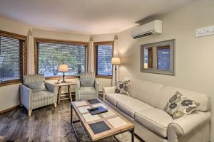 
a living room filled with furniture and a table at Condo with Resort Amenities - 1 Mile to Beach and Golf in Egg Harbor
