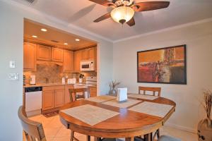 a kitchen with a wooden table and a ceiling fan at Bayfront Condo 3 Mi to Downtown St Petersburg in St Petersburg