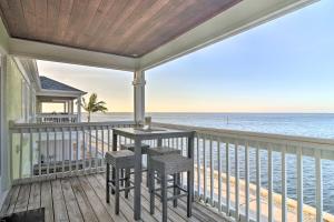 a balcony with a table and chairs on the beach at Bayfront Condo 3 Mi to Downtown St Petersburg in St Petersburg