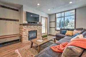 a living room with a couch and a fireplace at Solitude Mountain Slopeside Ski Condo with Hot Tub! in Brighton