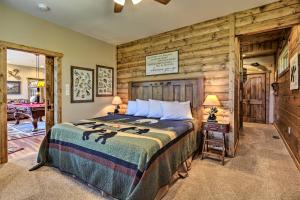 a bedroom with a bed and a wooden wall at Majestic Mtn Getaway Game Room, Decks and Hot Tub! in Gatlinburg