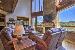 a living room with leather furniture and a fireplace at Majestic Mtn Getaway Game Room, Decks and Hot Tub! in Gatlinburg