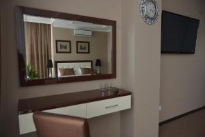 a hotel room with a mirror and a bed at Chernivtsi Arbat in Chernivtsi