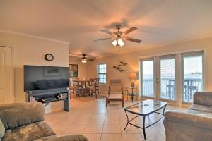 a living room with a couch and a tv at Bayfront Condo 3 Mi to Downtown St Petersburg in St Petersburg