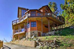 a large wooden house on top of a hill at Majestic Mtn Getaway Game Room, Decks and Hot Tub! in Gatlinburg