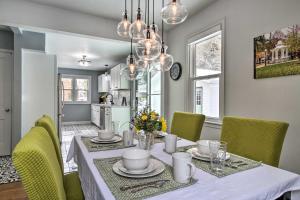 a dining room with a table and yellow chairs at Renovated Historic Home Less Than 1 Mile to Eagle Point! in Dubuque