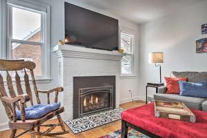 a living room with a fireplace with a tv above it at Renovated Historic Home Less Than 1 Mile to Eagle Point! in Dubuque