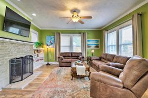 a living room with a couch and a fireplace at Beachside Getaway - Walk to Gulf, Pier and Casino! in Gulfport