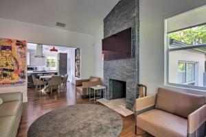 a living room with a fireplace and a dining room at Modern Miami Villa with Pool Oasis about 5 Mi to Beach! in Biscayne Park