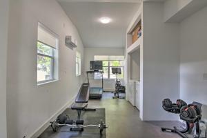 a gym with two chairs and weights in a room at Modern Miami Villa with Pool Oasis about 5 Mi to Beach! in Biscayne Park